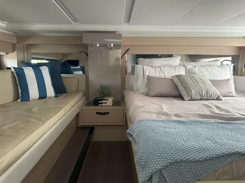 Slide: The Image of 2024 Jeanneau DB 43 cabin interior with bed, seating, and modern decor. - 36