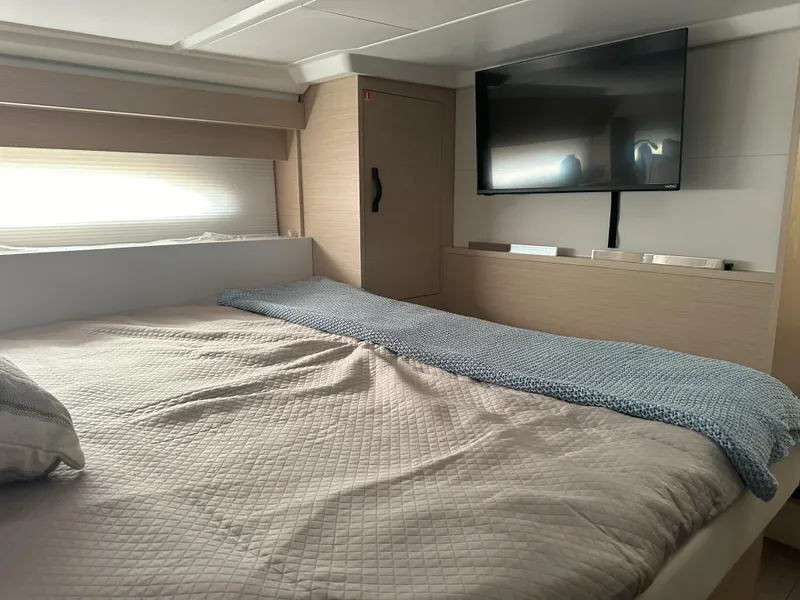 Slide: The Image of 2024 Jeanneau DB 43 cabin interior with bed, TV, and modern decor. - 39