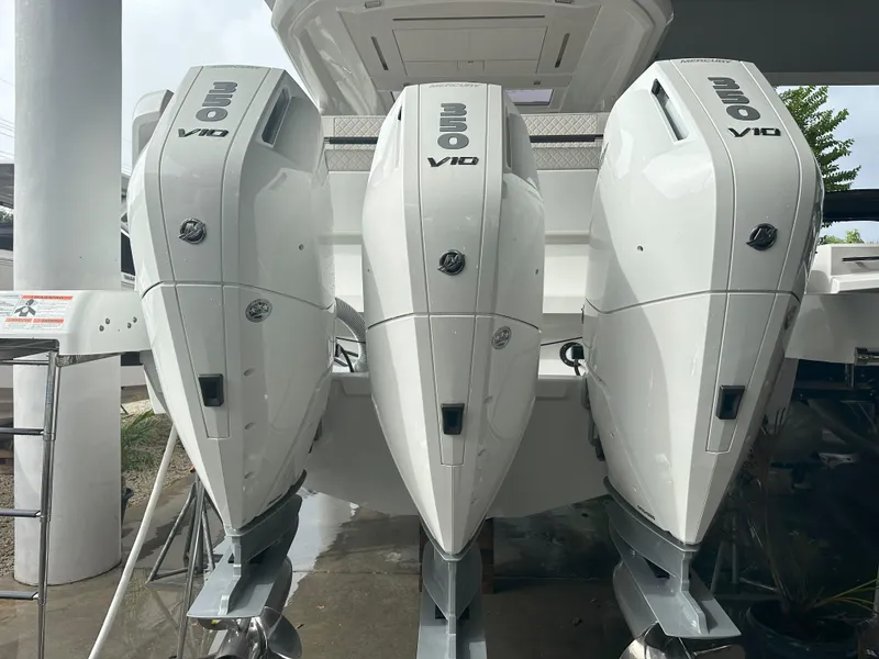 Slide: The Image of Triple outboard engines on a 2024 Jeanneau DB 43 boat, showcasing powerful performance. - 5