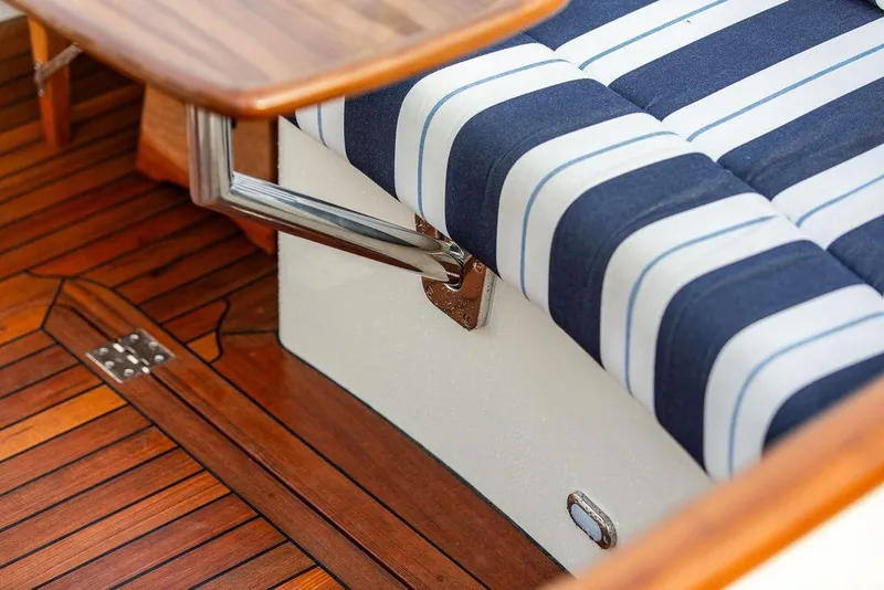 Slide: The Image of 2024 Hinckley 35 boat interior with wooden accents and modern controls. - 15