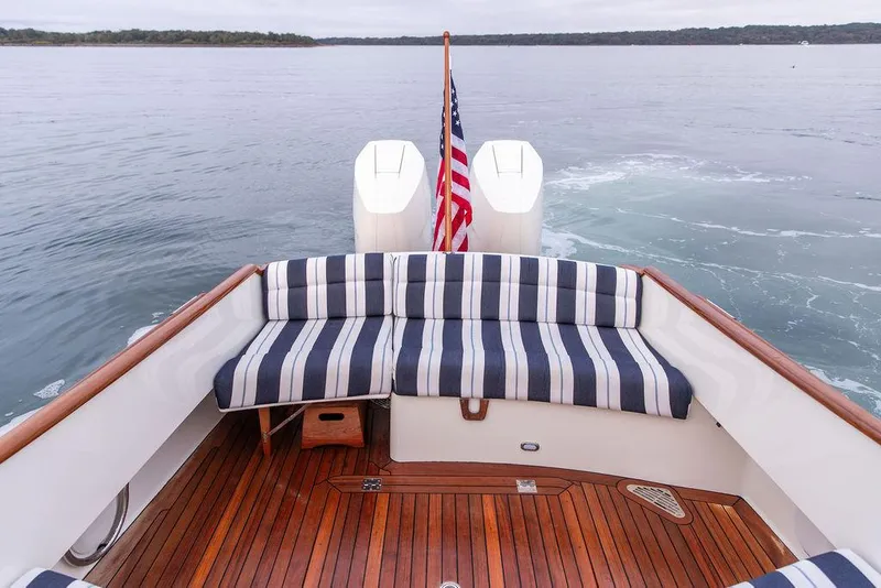 Slide: The Image of 2024 Hinckley 35 yacht interior with wooden dashboard and modern steering wheel. - 16