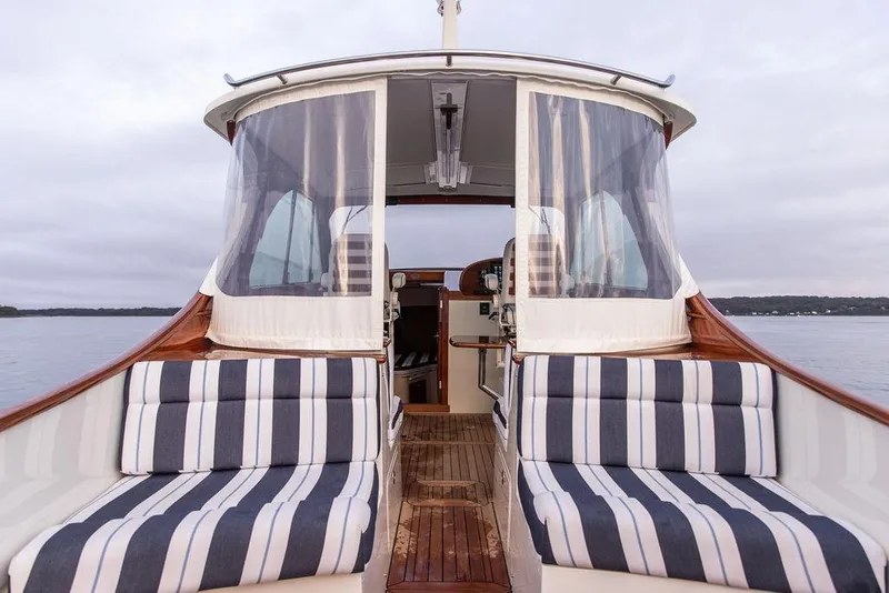 Slide: The Image of Hinckley 35 (2024) boat interior with teak flooring and black step detail. - 18