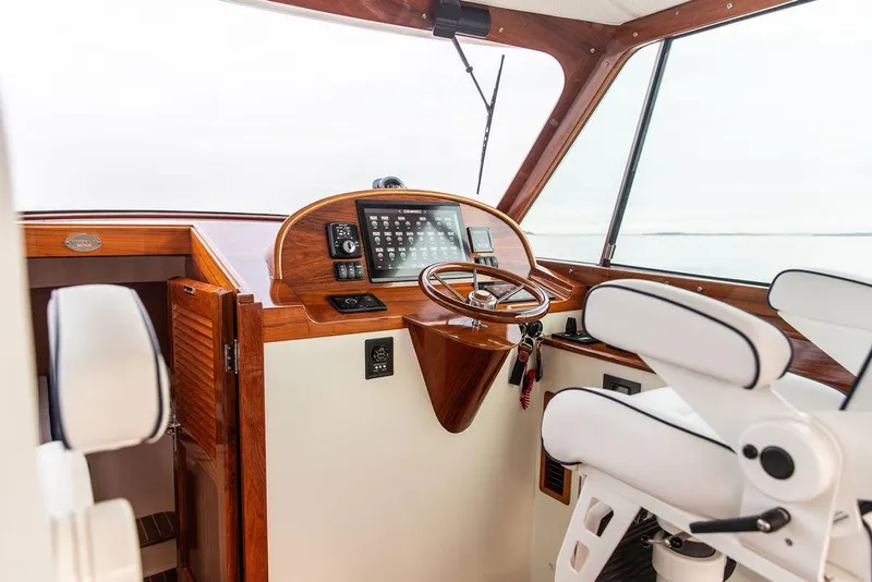 Slide: The Image of 2024 Hinckley 35 yacht control panel with advanced navigation and throttle system. - 21