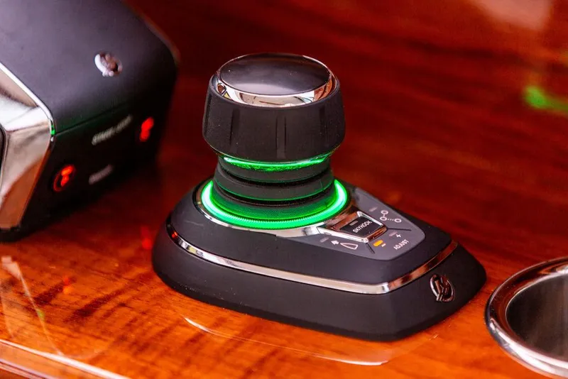 Slide: The Image of 2024 Hinckley 35 interior with polished wood finish and modern control panel. - 24