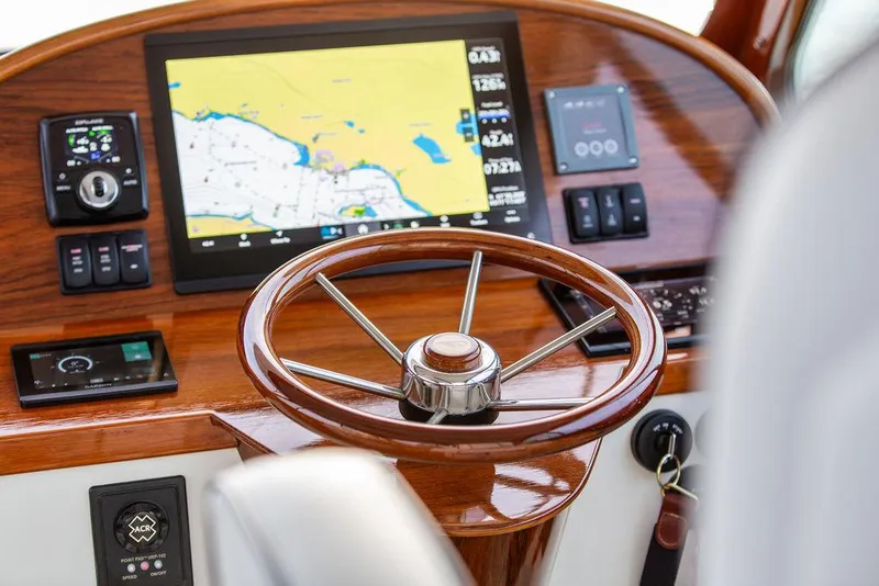 Slide: The Image of 2024 Hinckley 35 yacht interior with control panel and wooden accents. - 25
