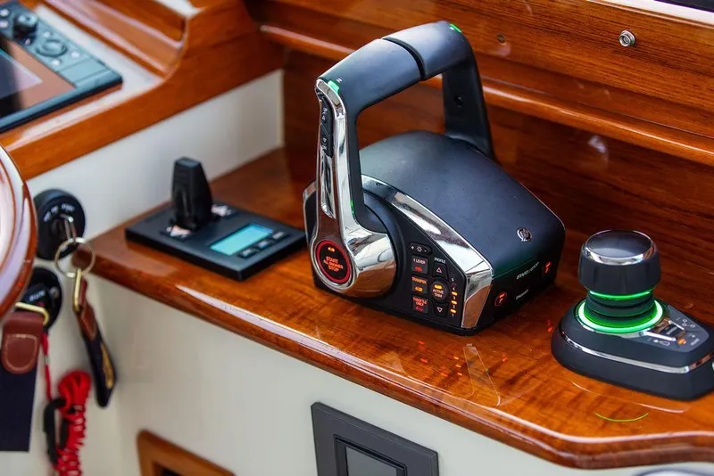 Slide: The Image of Interior of 2024 Hinckley 35 yacht with striped seating and wooden accents. - 27