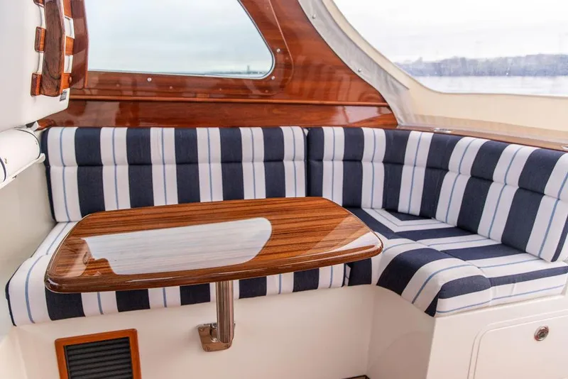 Slide: The Image of 2024 Hinckley 35 boat with American flag, named "Carol I," docked in Nantucket. - 37