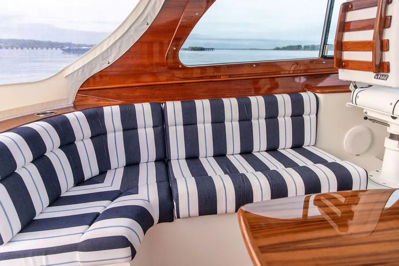 Slide: The Image of Interior ceiling of a 2024 Hinckley 35 boat, featuring sleek wood paneling and lighting. - 38