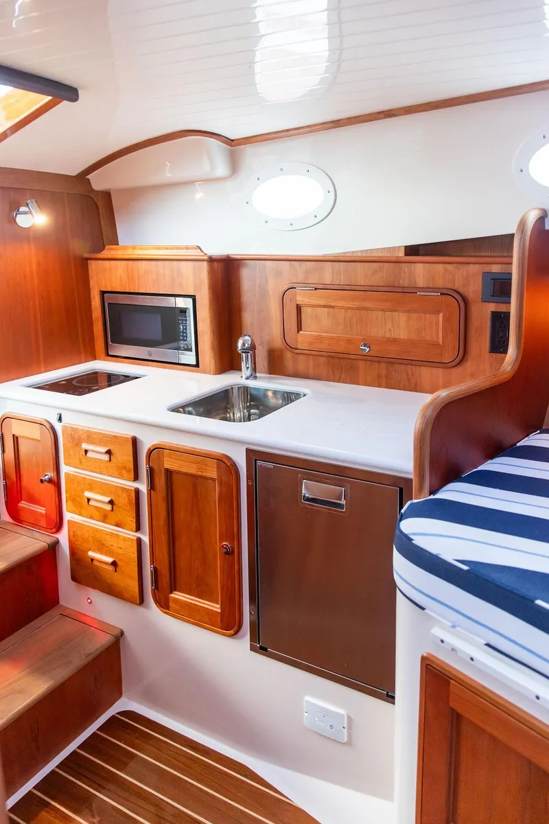 Slide: The Image of 2024 Hinckley 35 yacht bathroom with wooden cabinetry and modern sink. - 47