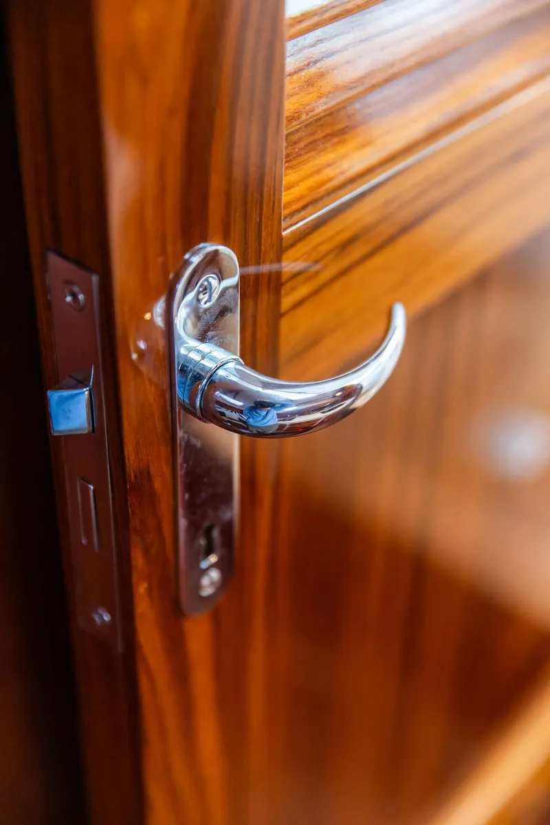 Slide: The Image of 2024 Hinckley 35 boat interior with striped seating and wooden deck. - 54