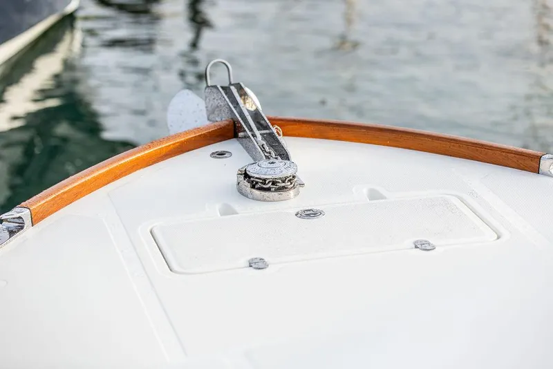 Slide: The Image of 2024 Hinckley 35 boat cruising on calm water with American flag. - 59