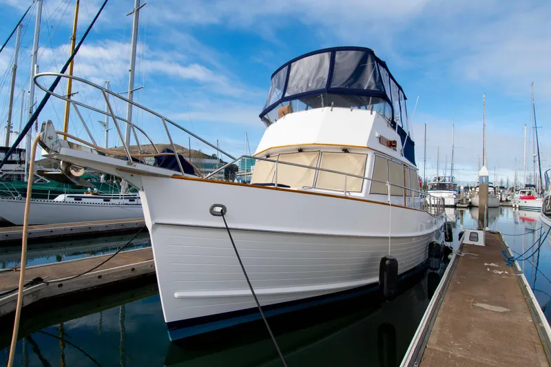 Slide: The Image of Grand Banks 42 Classic yacht, 2000 model, docked at marina under blue sky. - 11