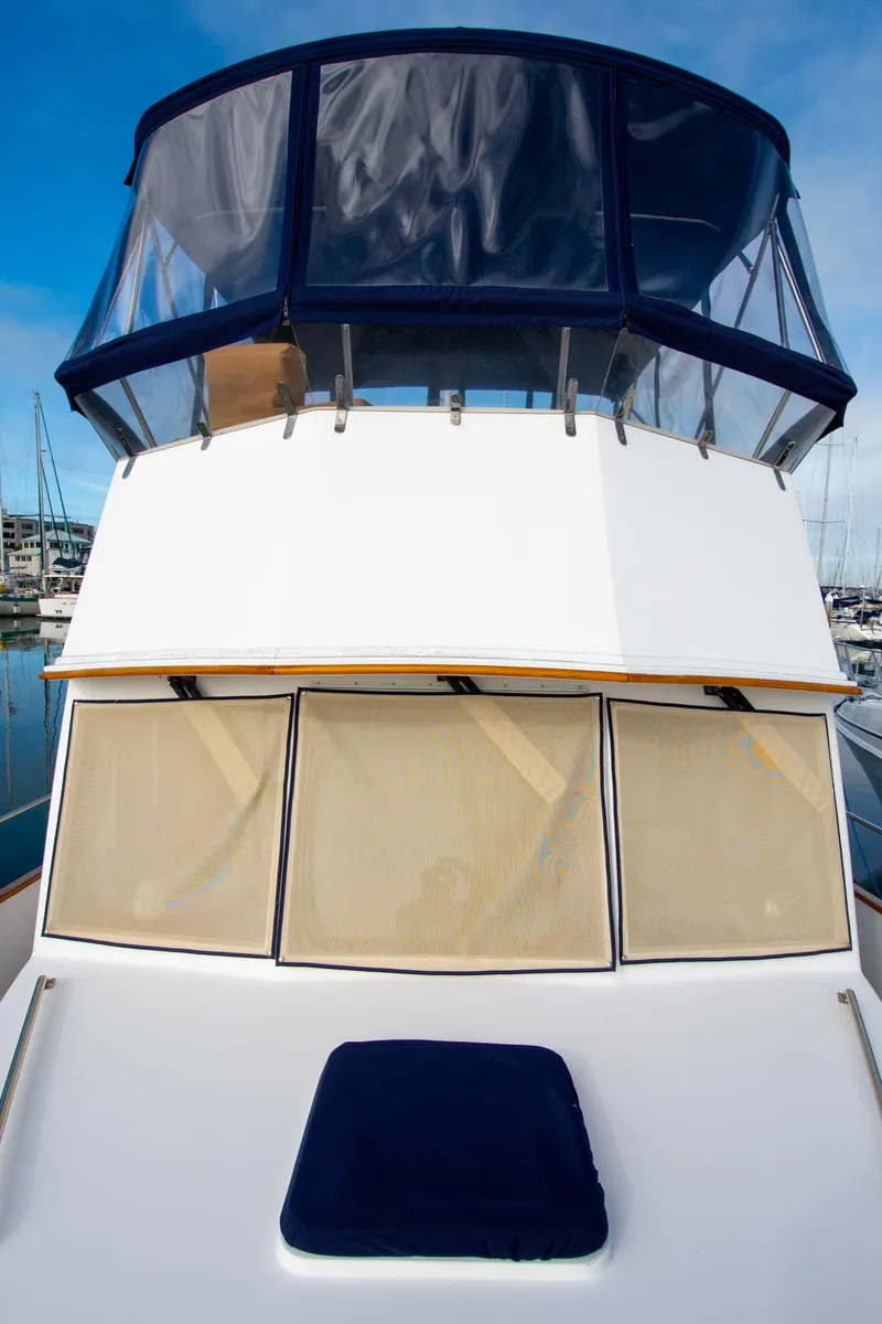 Slide: The Image of Grand Banks 42 Classic 2000 yacht with blue canopy and beige window covers. - 14
