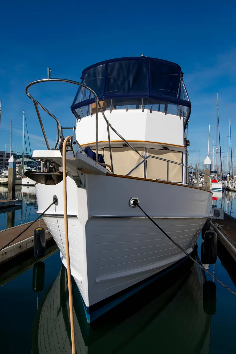 Slide: The Image of Grand Banks 42 Classic yacht, 2000 model, docked in a marina under clear blue skies. - 20