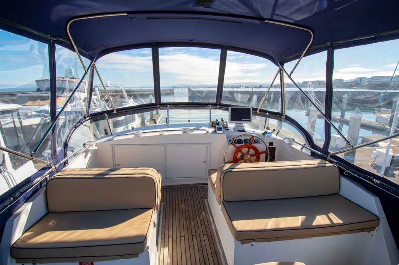 Slide: The Image of Grand Banks 42 Classic 2000 yacht interior with helm, seating, and marina view. - 21