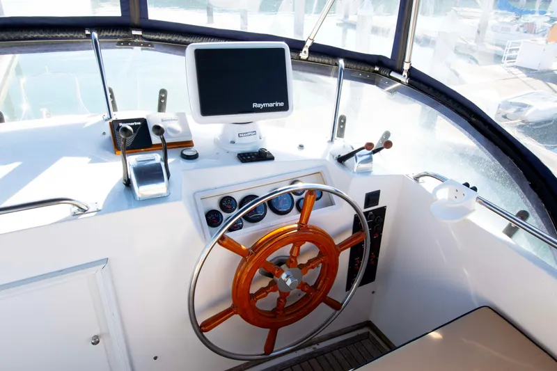 Slide: The Image of Helm of 2000 Grand Banks 42 Classic yacht with wooden wheel and navigation equipment. - 22