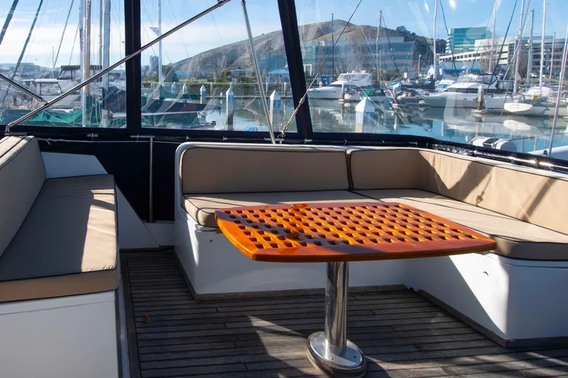 Slide: The Image of Interior of 2000 Grand Banks 42 Classic yacht with seating and table, docked at marina. - 24