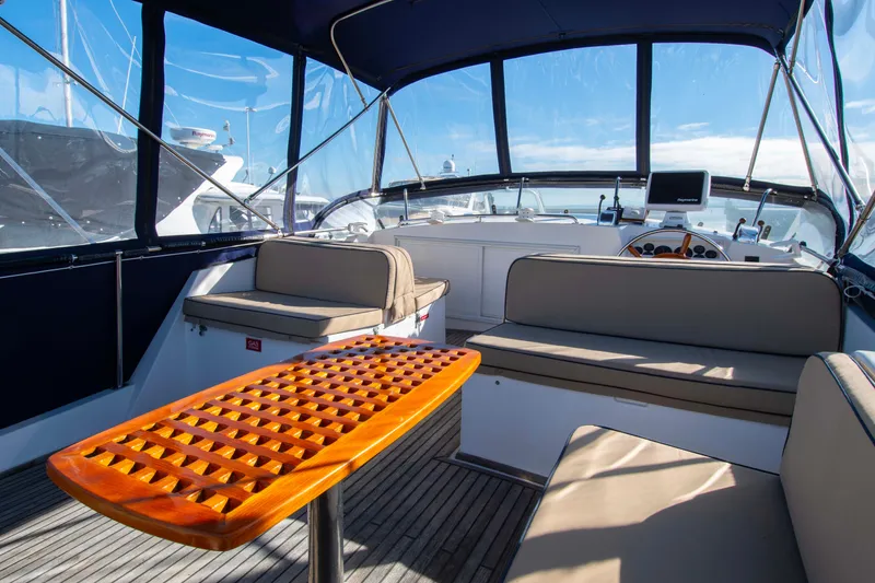 Slide: The Image of Spacious deck of 2000 Grand Banks 42 Classic yacht with seating and wooden table. - 25