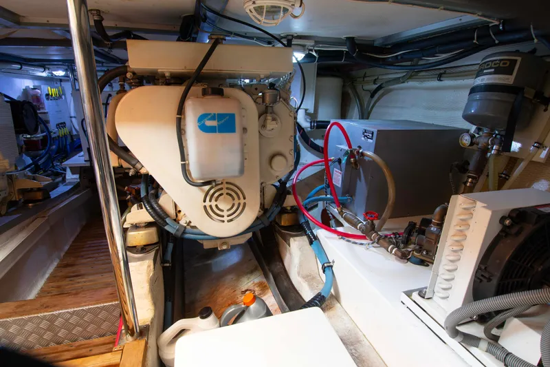 Slide: The Image of Engine room of 2000 Grand Banks 42 Classic yacht, showcasing mechanical components and equipment. - 27