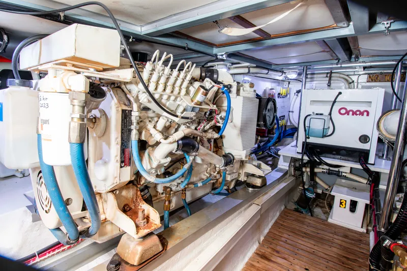 Slide: The Image of Engine room of 2000 Grand Banks 42 Classic yacht, featuring Onan generator and mechanical components. - 29