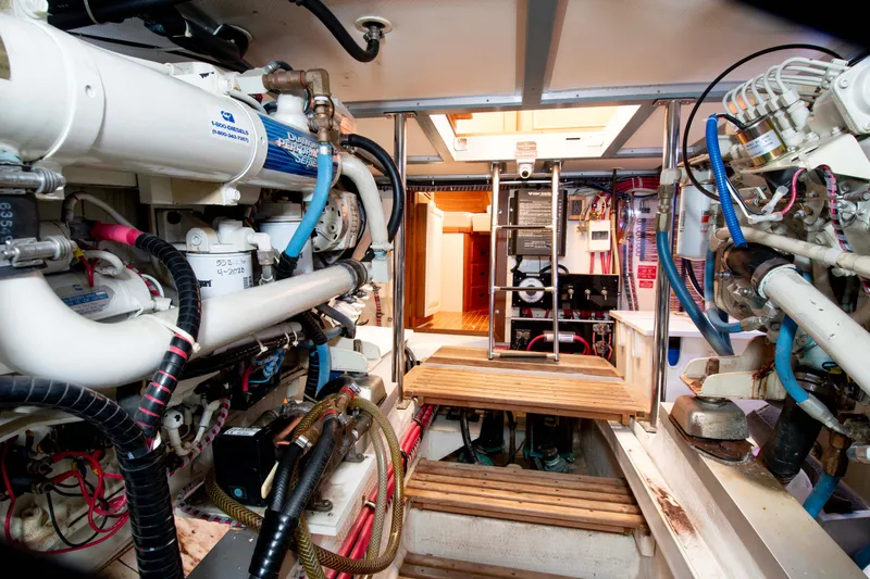 Slide: The Image of Engine room of 2000 Grand Banks 42 Classic yacht, showcasing mechanical components and equipment. - 30