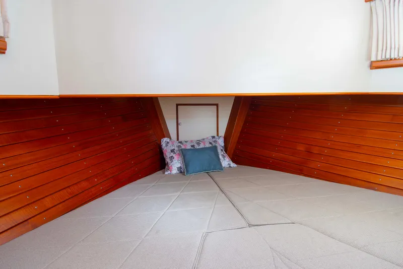 Slide: The Image of Cozy cabin interior of 2000 Grand Banks 42 Classic with wooden paneling and cushions. - 31