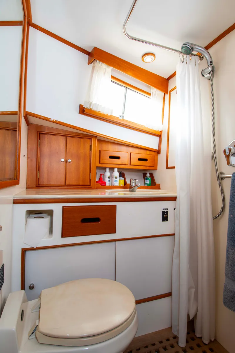 Slide: The Image of Bathroom interior of 2000 Grand Banks 42 Classic yacht with shower and wooden cabinets. - 32