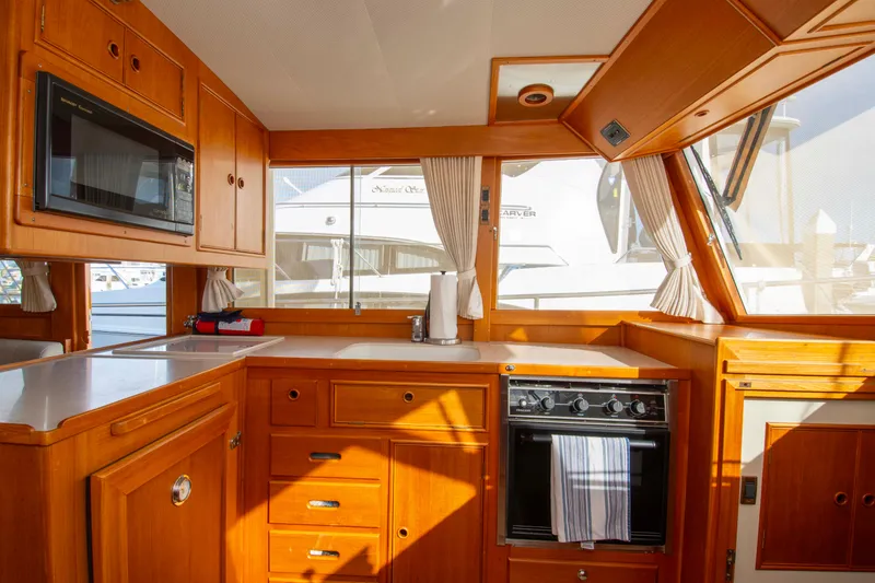 Slide: The Image of Interior of 2000 Grand Banks 42 Classic yacht kitchen with wood cabinetry and appliances. - 33