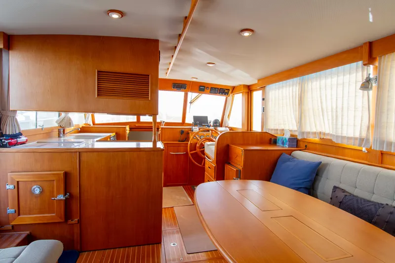Slide: The Image of Interior of 2000 Grand Banks 42 Classic yacht with wooden furnishings and cozy seating area. - 38