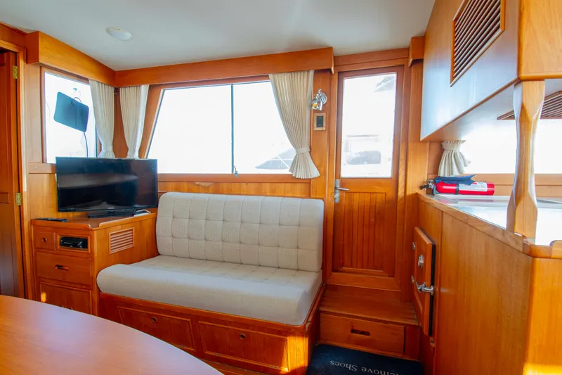 Slide: The Image of Interior of 2000 Grand Banks 42 Classic yacht with cozy seating and wooden finishes. - 40