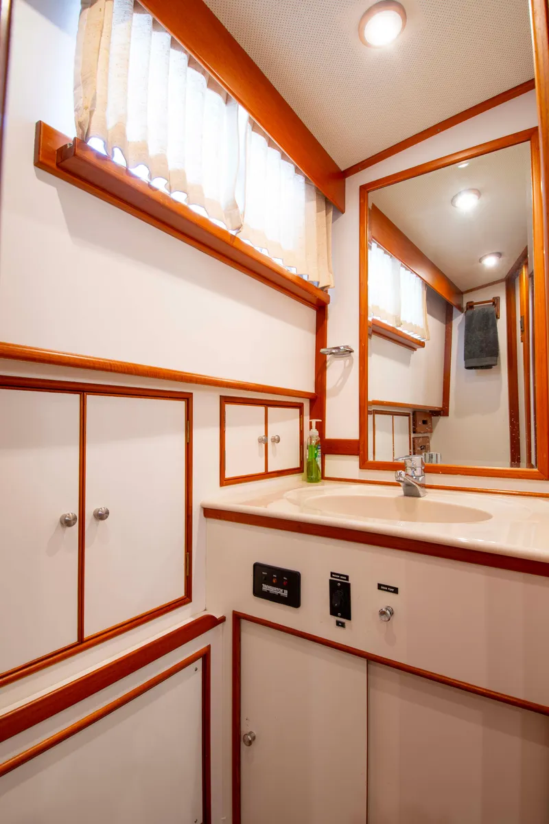 Slide: The Image of Elegant bathroom interior of 2000 Grand Banks 42 Classic yacht with wood accents. - 41
