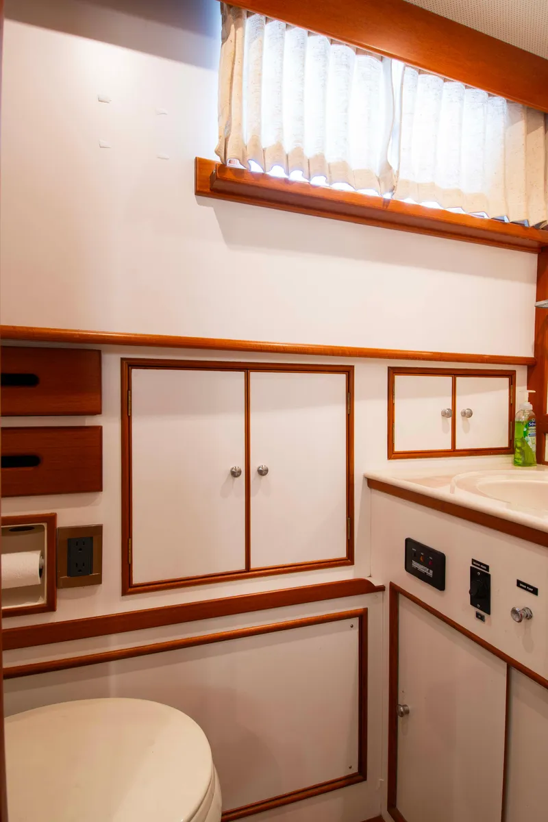 Slide: The Image of Interior of 2000 Grand Banks 42 Classic yacht bathroom with wood accents and cabinetry. - 42