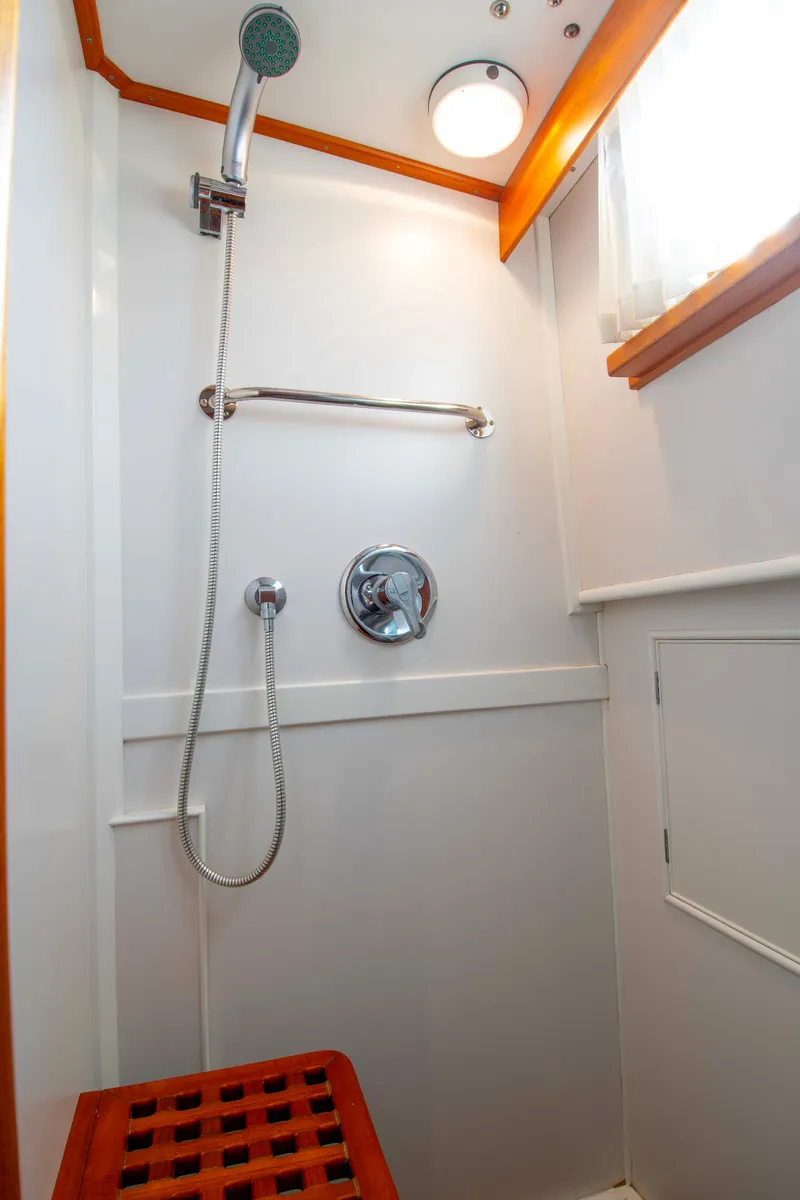 Slide: The Image of Shower area in 2000 Grand Banks 42 Classic yacht with wooden accents. - 43