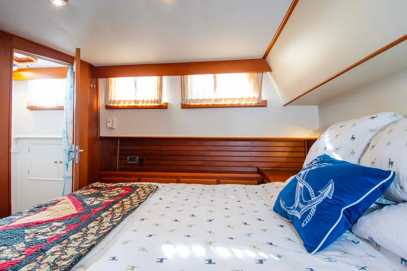 Slide: The Image of Cozy bedroom in 2000 Grand Banks 42 Classic yacht with nautical-themed decor. - 45