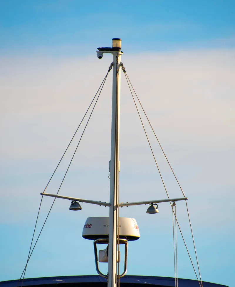 Slide: The Image of Mast of 2000 Grand Banks 42 Classic yacht against blue sky. - 49