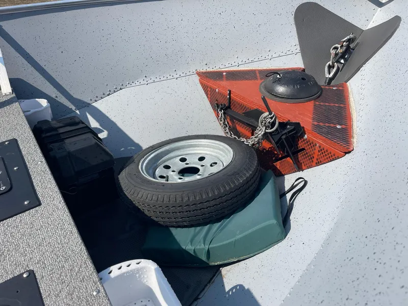 Slide: The Image of 2025 Lund SSV-16 Tiller boat interior with spare tire and anchor. - 10