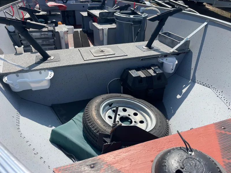 Slide: The Image of 2025 Lund SSV-16 Tiller boat interior with spare tire and equipment storage. - 11