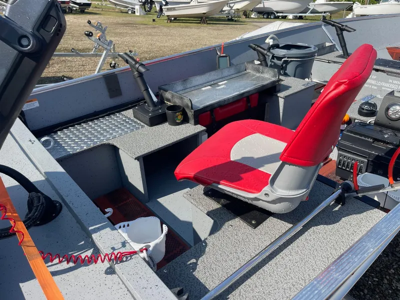 Slide: The Image of 2025 Lund SSV-16 Tiller boat interior with red seat and control panel. - 7