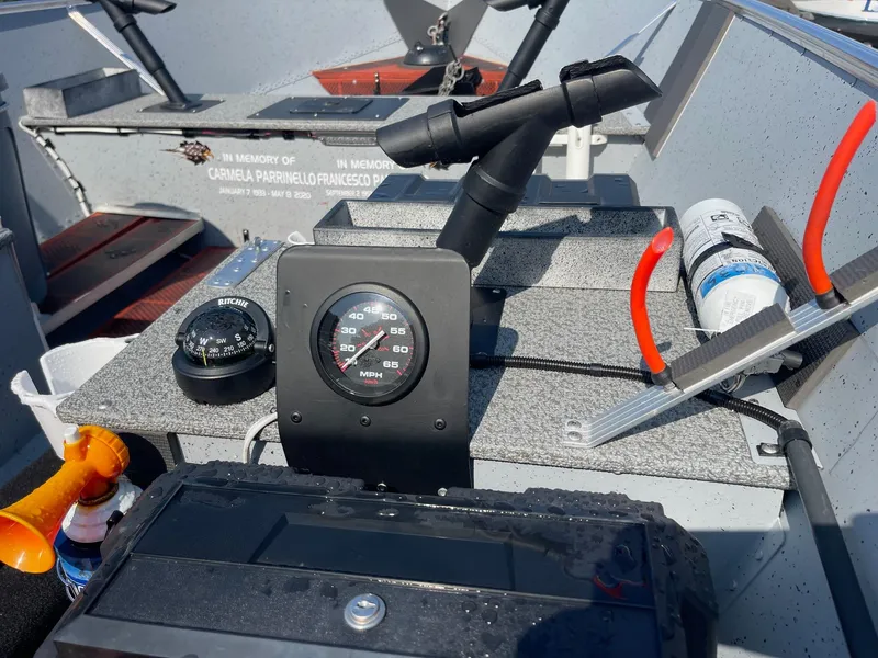 Slide: The Image of 2025 Lund SSV-16 Tiller boat dashboard with compass, speedometer, and accessories. - 8