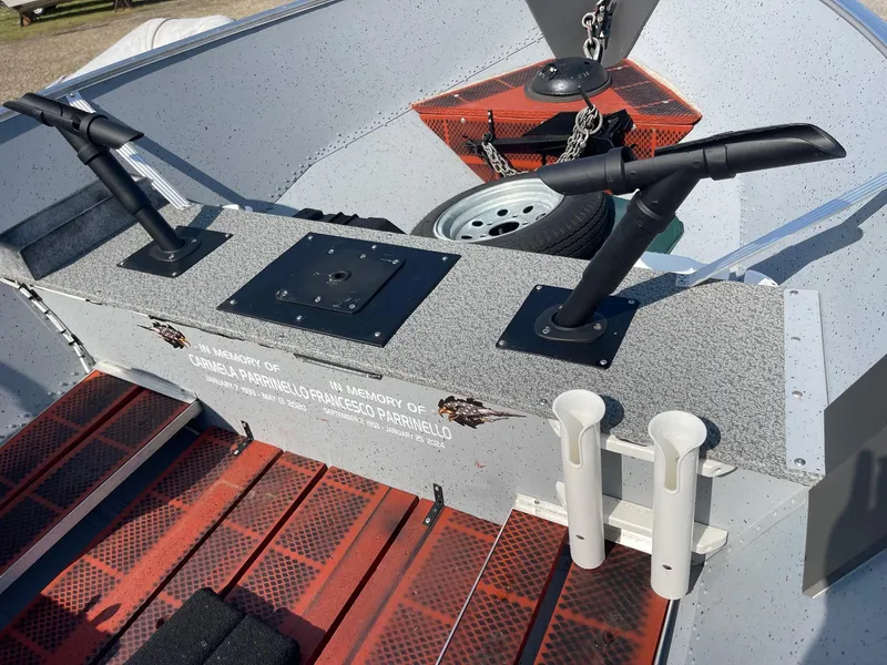 Slide: The Image of 2025 Lund SSV-16 Tiller boat interior with rod holders and anchor chain. - 9