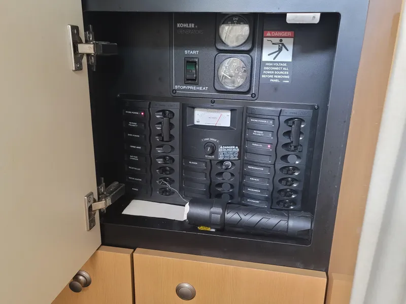 Slide: The Image of Electrical panel inside a 2004 Maxum 3100 SE boat, featuring switches and gauges. - 10