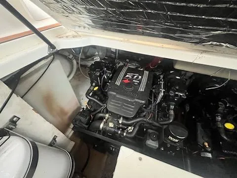 Slide: The Image of Engine compartment of a 2004 Maxum 3100 SE boat, showcasing the engine and components. - 12