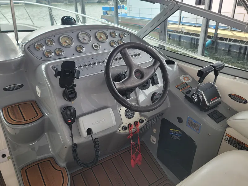 Slide: The Image of 2004 Maxum 3100 SE boat cockpit with steering wheel and control panel. - 15