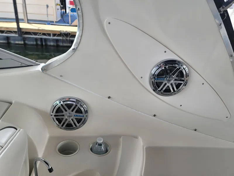 Slide: The Image of 2004 Maxum 3100 SE boat interior with speakers and cup holder. - 16