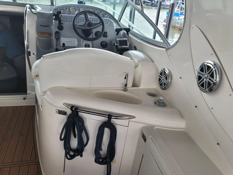 Slide: The Image of 2004 Maxum 3100 SE boat interior with steering wheel and seating area. - 17