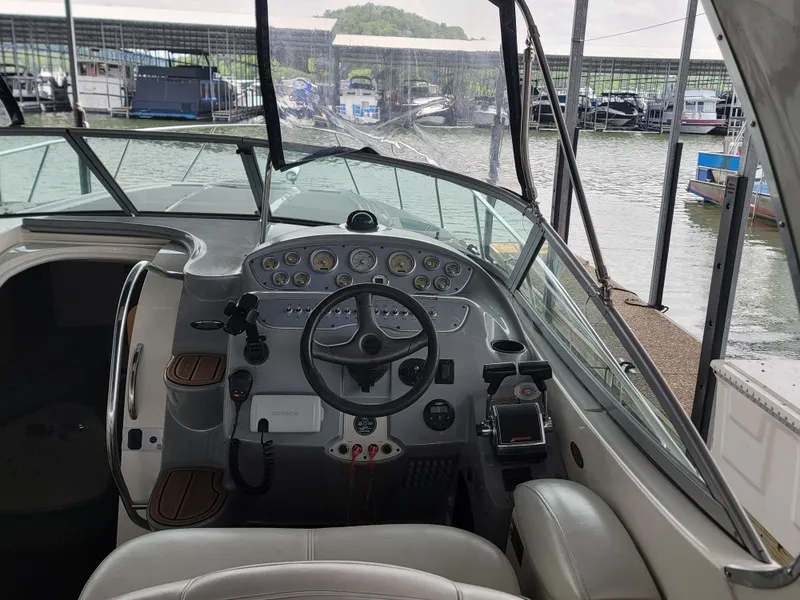 Slide: The Image of 2004 Maxum 3100 SE boat cockpit with steering wheel and control panel at marina. - 22