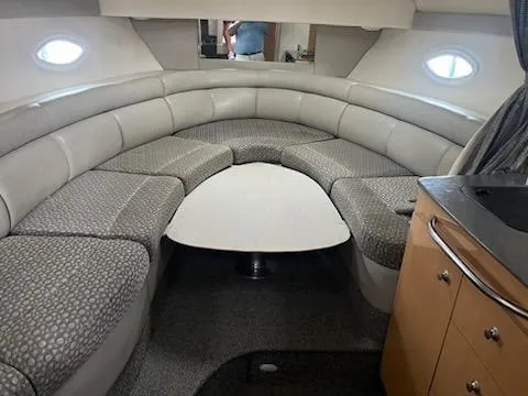 Slide: The Image of 2004 Maxum 3100 SE cabin interior with curved seating and table. - 5