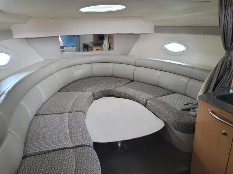 Slide: The Image of 2004 Maxum 3100 SE boat interior with curved seating and table. - 8