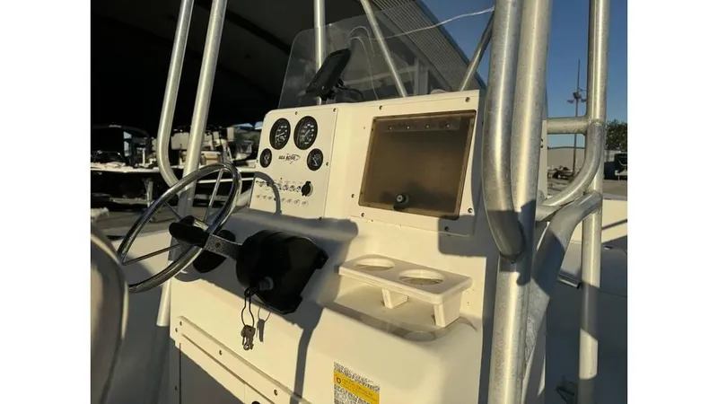 Slide: The Image of 2004 Sea Boss 190 Center Console boat dashboard with steering wheel and gauges. - 3