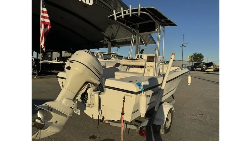 Slide: The Image of 2004 Sea Boss 190 Center Console boat on trailer, parked outdoors. - 4